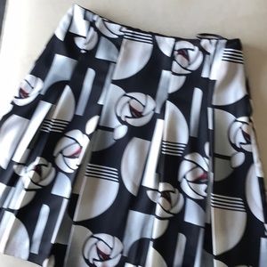 Satin like a-line skirt with gentle pleats.